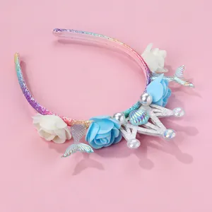 Detail of mermaid themed headband with glitter sequins, shell, crown and faux flowers