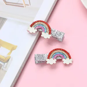 Close-up of glitter rainbow hair clips with white clouds and sparkling sequins