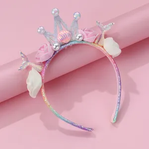 Close-up of glitter mermaid tail and floral crown details on girls hairband