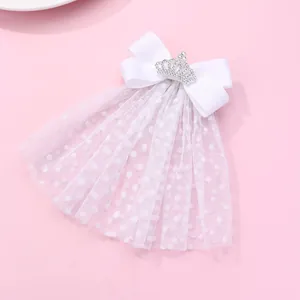 Détail de la pince à cheveux noeud blanc en tulle pailleté avec strass de couronne