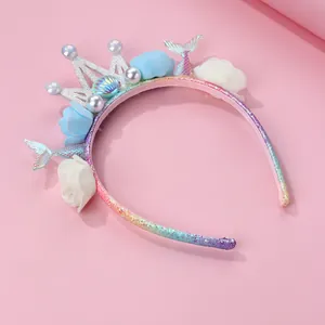 Detail of mermaid tail hairband with crown, colorful shells and delicate foam roses