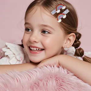 Girl wearing glittery rainbow cloud hair clips and sparkling diamond stud earrings