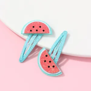 Detail of glittery watermelon fruit BB hair clips for girls in blue and red