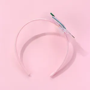 Detail of pink glitter headband featuring mesh lace and decorative geometric slices