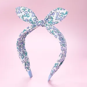 Detail of floral fabric headband with blue rabbit ears and non-slip ribbon ends