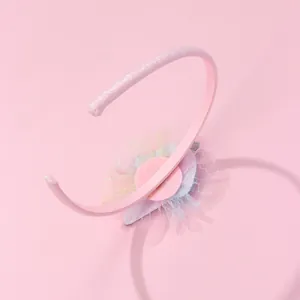 Detailed macro view of pink glitter headband with mesh lace and sequin ice cream decor