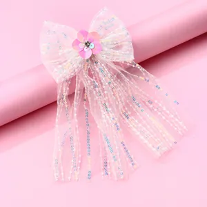 Barrette à nœud en tulle rose avec paillettes, perles et longs glands décoratifs
