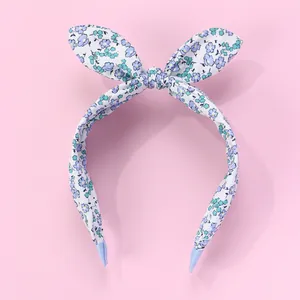 Detail of floral rabbit ear headband featuring violet blossoms and anti-slip blue tips