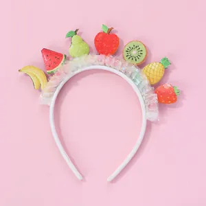 Detail of children's headband with colorful sequin fruit patches and white lace mesh