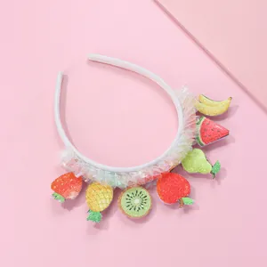 Detailed view of children's sequined fruit headband with white lace trim and glitter icons