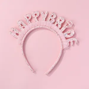 Dettaglio di cerchietto rosa glitterato con scritta Happy Bride e pizzo delicato