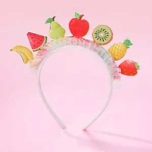 Detail of sweet fruit headbands featuring colorful sequins, white mesh and assorted fruit icons