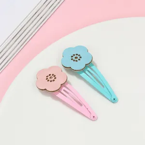 Detail of pink and blue hollow flower hair clips with scalloped petals on metal BB clips