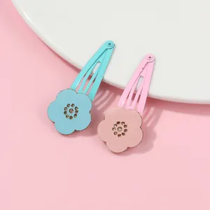 Detail of blue and pink floral BB hair clips with glitter centers for girls