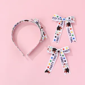 Detailed view of white graduation headbands and clips with party time print and stars
