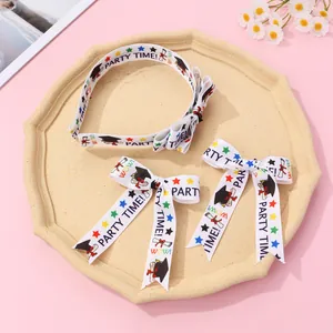 Detail of graduation bow tie and clips with party time print and mortarboard icons