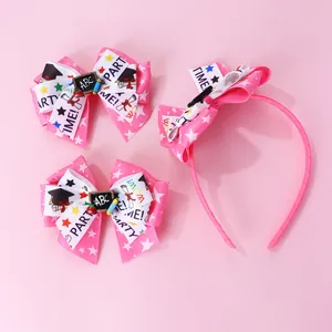 Detail of pink back-to-school bow headband and clips with mini chalkboard and cap elements