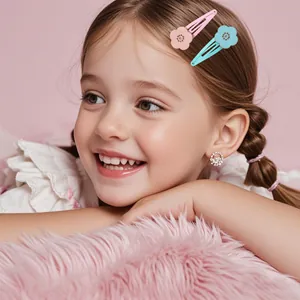 Detail of floral metal hair clips and sparkling stud earrings for young girls