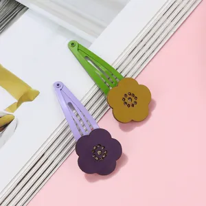 Close-up of hollow flower BB hair clips with colorful petals and sparkling center crystals