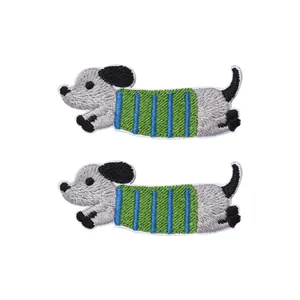 Pair of embroidered dachshund dog hair clips with striped sweaters on white background