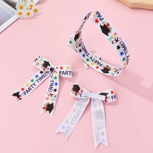 Graduation party headpiece set featuring bow hair clips and academic cap prints