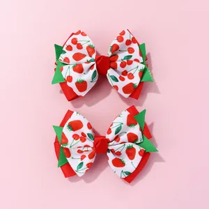 Detail of sweet strawberry and cherry print double-layer bow hair clips for girls