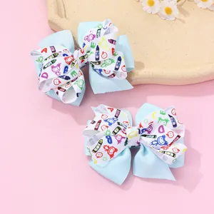 Vue détaillée de deux barrettes à nœuds superposés avec motifs gribouillis d'école mignons