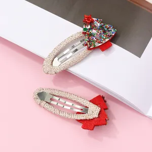 Detail of Christmas tree hair clips with colorful sequins and silver metal base