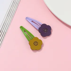 Close-up of hollow flower BB hair clips with leather texture and sparkling glitter centers
