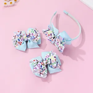 Close-up of light blue ribbon hairband and bow clips with colorful doodle patterns