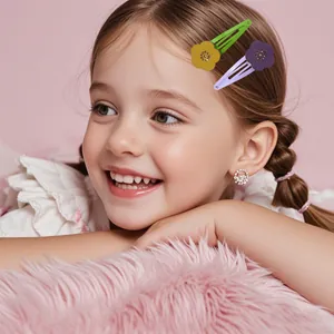 Detail of floral hair clips and sparkling stud earrings on a smiling young girl