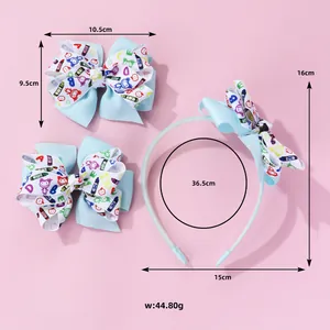 Detailed view of blue graffiti bow headband and hair clip set for kids on pink background