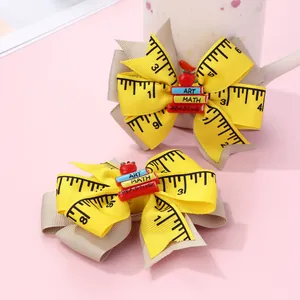 School-themed bow hair clips set with ruler prints, mini books, and red apple details