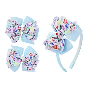 Detail of school-style hairband and clips with blue ribbons and colorful doodle patterns