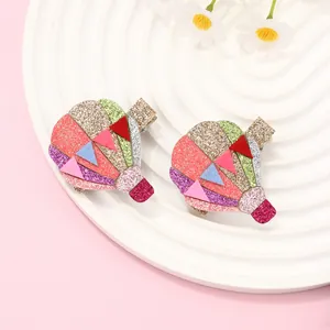 Sparkly glitter hot air balloon hair clips for girls set on a decorative plate