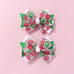 Detail view of double-layered watermelon pattern bow hair clips for girls in a two-piece set