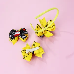 Detail of school bow headband set with ruler print and Happy Teacher's Day apple