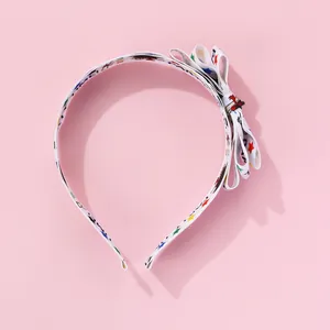 Detail of multi-layered bow headband with star patterns and Party Time print text