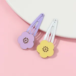 Close-up of hollow flower BB hair clips with purple and yellow felt petals for children