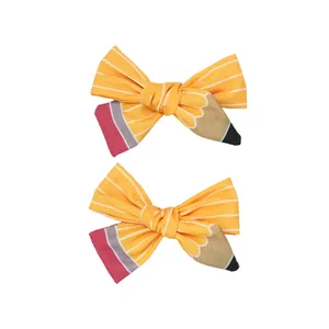 Paire de barrettes nœuds style crayon jaune avec tissu rayé pour la rentrée scolaire