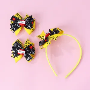 Detail of Teacher's Day hairband and bow clips with yellow ribbon and apple motifs