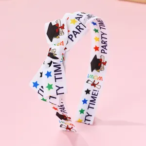 Detail of preppy school bow headband with graduation caps and party time prints