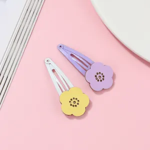 Close-up of hollow flower BB clips in purple and white with yellow resin petals