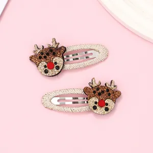 Detail shot of Christmas reindeer hair clips with glitter accents and gold woven wrapping
