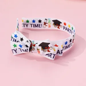 Detail of preppy style headband with double-layered bow and graduation party patterns
