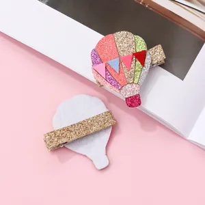 Detail view of colorful glitter hot air balloon hair clip with metallic duckbill clamp