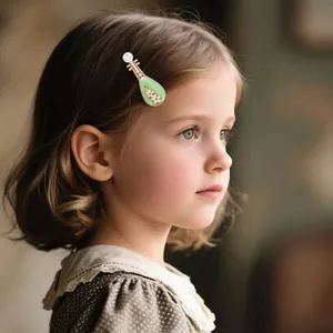 Detail view of a vintage lute-shaped hair clip with pearls and pink flowers on a model