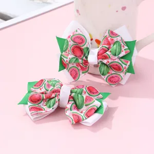 Detailed view of handmade double-layered bow hair clips with cute watermelon pattern prints