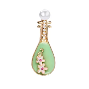 Detailed Pipa lute brooch with emerald green enamel and delicate white pearl accents