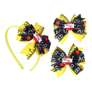 Close-up of school-themed bow headband and hair clips with apple and ruler patterns
